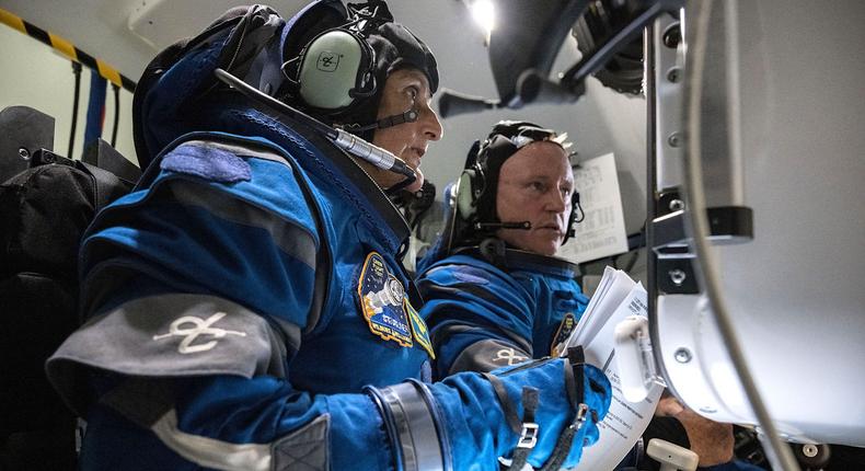 NASA astronauts Suni Williams (left) and Butch Wilmore (right) conduct suited operations in a Boeing Starliner simulator.NASA/Robert Markowitz