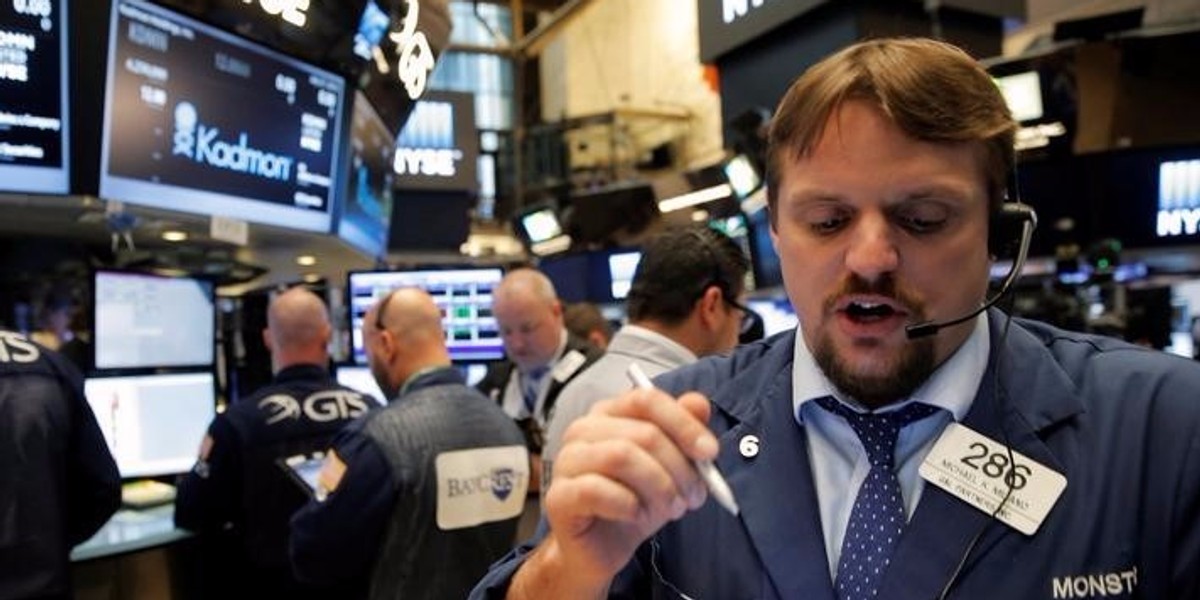 Traders work on the floor of the NYSE