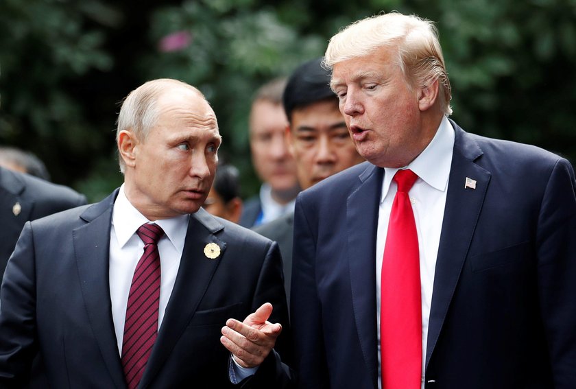 U.S. President Donald Trump and Russia's President Vladimir Putin talk during the family photo sessi