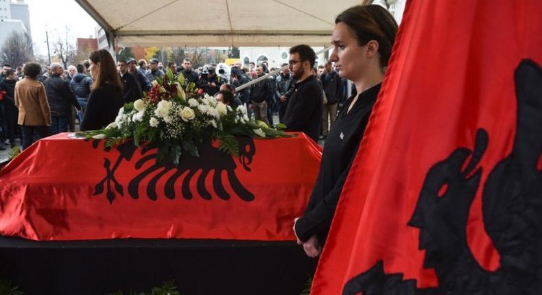 Kosovo Albanians pay their respects beside the casket of opposition activist Astrit Dehari after his death in prison, which authorities said was suicide