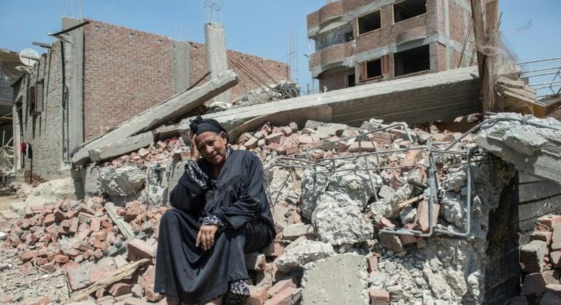 Egyptian Shoukran Rashwan, 75, sits on the rubble of her demolished house on Cairo's Warraq island on July 20, 2017