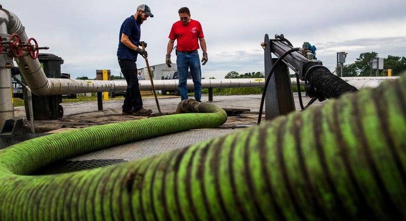 Technician David Sandstrom of Vanguard Renewables works with Frank Lopez of Chase/Harris Septic Corp to pump waste into the anaerobic digester at the Jordan Dairy Farms Heifer Facility in Spencer, MA on June 5, 2020.