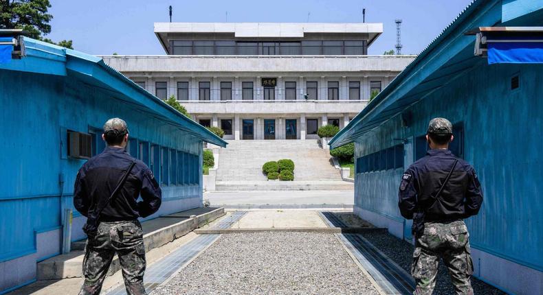 South Korean soldiers stand guard as they face North Korea's Panmon Hall (back) at the truce village of Panmunjom in the Joint Security Area (JSA) of the Demilitarized Zone (DMZ) separating North and South Korea.Anthony Wallace/AFP via Getty Images