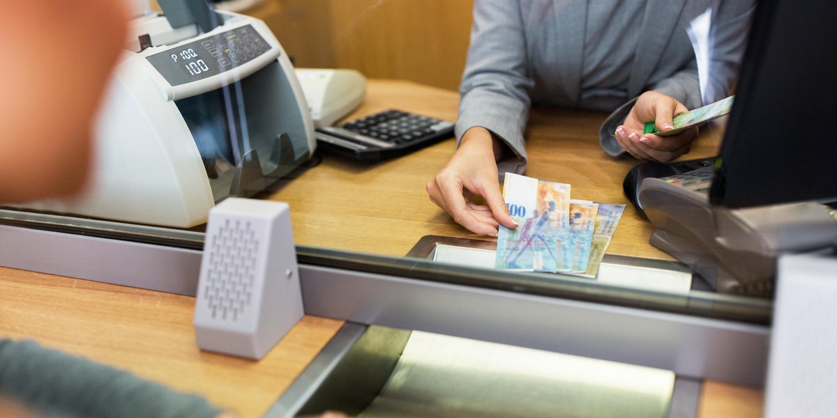 clerk counting cash money at bank office