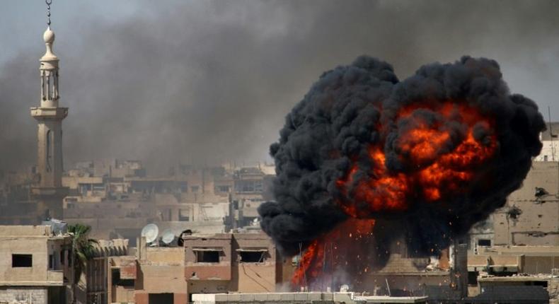 A ball of fire rises from a building following a reported air strike on June 11, 2017 by Syrian forces on a rebel-held area in the southern city of Daraa, which was among areas where a ceasefire took effect on Sunday