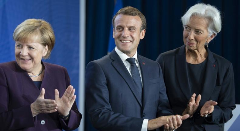 New ECB head Christine Lagarde (right) wants Germany Chancellor Angela Merkel (left) to increase public spending to give the sluggish European economy a boost, a move supported by French President Emmanuel Macon (centre)