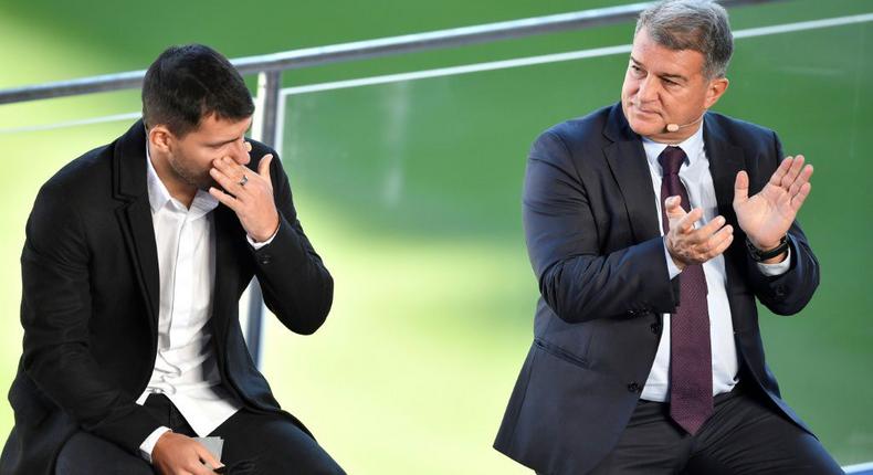 A tearful Sergio Aguero (L) with Barcelona president Joan Laporta at a press conference at the Camp Nou to announce his retirement from football on Wednesday