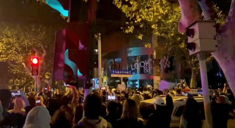 People protest against coronavirus disease (COVID-19) curbs, at the site of a candlelight vigil for victims of the Urumqi fire, in Shanghai, China, in this screengrab from a video realeased on November 27, 2022.Reuters