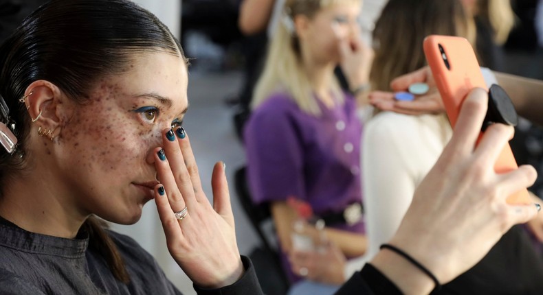 A model takes a selfie photograph backstage before the House of Holland Autumn/Winter 2019 fashion week runway show in London, Saturday, Feb. 16, 2019.(Photo by Grant Pollard/Invision/AP)