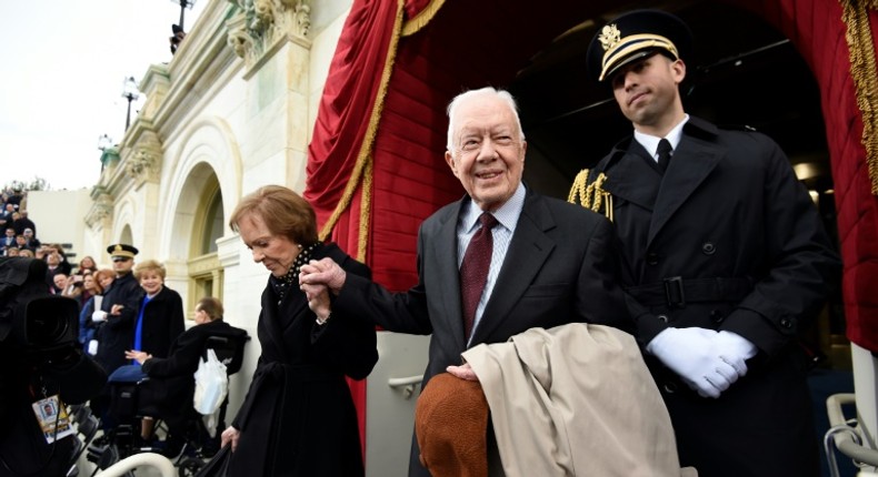 US President Jimmy Carter, who suffered a fall at his home in Plains, Georgia, is pictured here with First Lady Rosalynn Carter arriving at Donald Trump's inauguration January 20, 2017