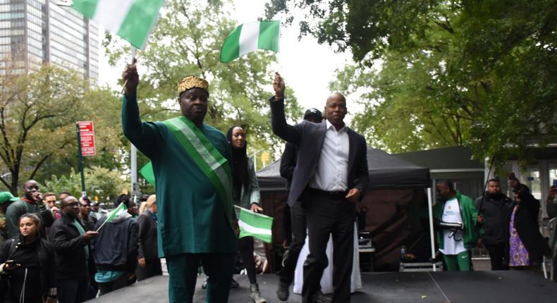 (Left) Consul-General of Nigeria in New York, Amb. Lot Egopija and New York City Mayor, Mr Eric Adams raising Nigeria flag at a Carnival to commemorate 62nd Nigeria Independence Day in New York on Saturday in New York.