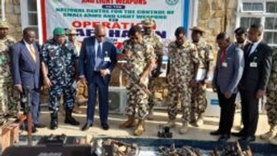 OPSH Commander, Maj.-Gen. Abdusalam Abubakar, handing over recovered illegal weapons to Maj.-Gen. Hamza Bature, the North-Central Coordinator of NCCSALW in Jos. (Credit: NAN)