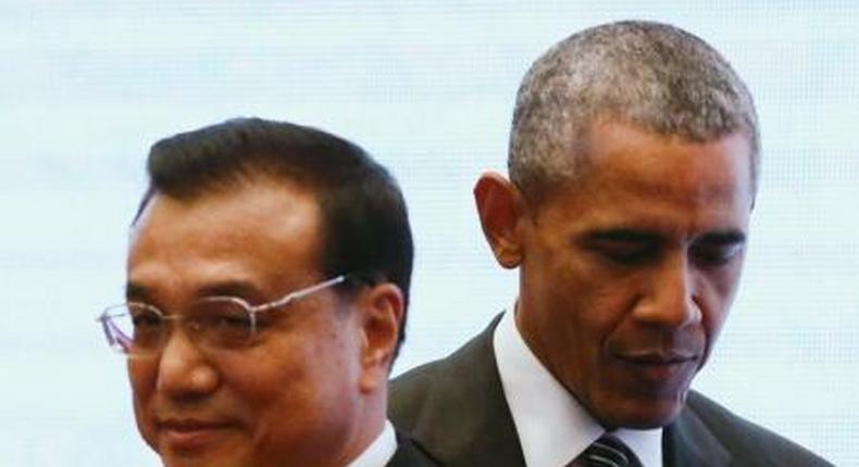 U.S. President Barack Obama walks behind Chinas Premier Li Keqiang as they attend a family photo at the 27th Association of Southeast Asian Nations (ASEAN) Summit in Kuala Lumpur, Malaysia, November 22, 2015.