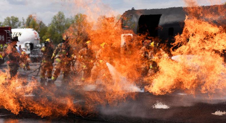 U.S. Air Force firefighters, assigned to the 180th Fighter Wing, Ohio Air National Guard, spray water on a fire May 10, 2018 during training exercises at the Toledo Express Airport in Swanton, Ohio.