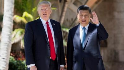 Chinese President Xi Jinping (right) waves to the press as he walks with US President Donald Trump at the Mar-a-Lago estate in West Palm Beach, Florida, April 7, 2017