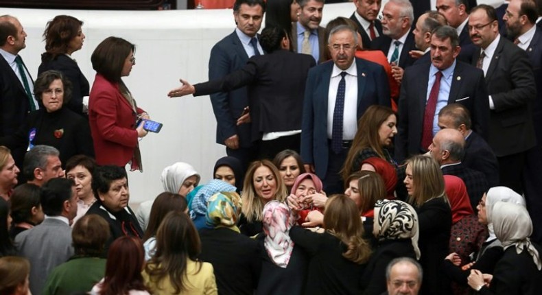 Ruling AK Party and opposition lawmakers scuffle after Turkish deputy Aylin Nazliaka (C) handcuffed herself to the podium in a protest against the constitutional reform aimed at strengthening the powers of the Turkish president on January 19, 2017