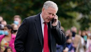White House chief of staff Mark Meadows speaks on a phone on the South Lawn of the White House in Washington, Friday, Oct. 30, 2020, before President Donald Trump's departure on Marine One.