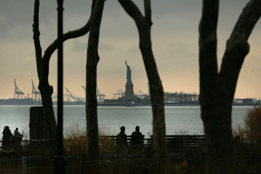 A sign announcing the closure of the Statue of Liberty, due to the U.S. government shutdown, sits ne