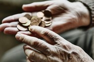 Senior woman's hands with coins