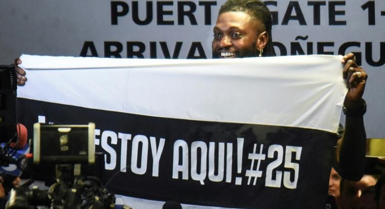 Togo forward Emmanuel Adebayor holds up a message to his new fans at Paraguay champions Olimpia on his arrival in Asuncion