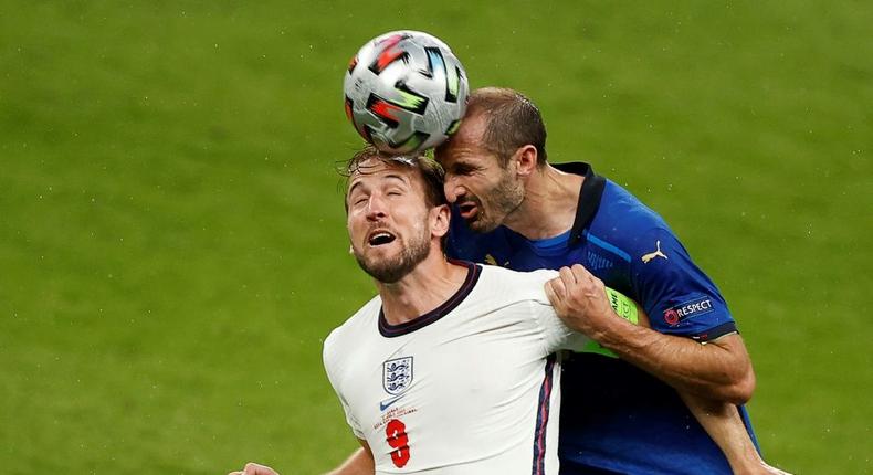 Italy defender Giorgio Chiellini (R) vies for the header with England's Harry Kane Creator: JOHN SIBLEY