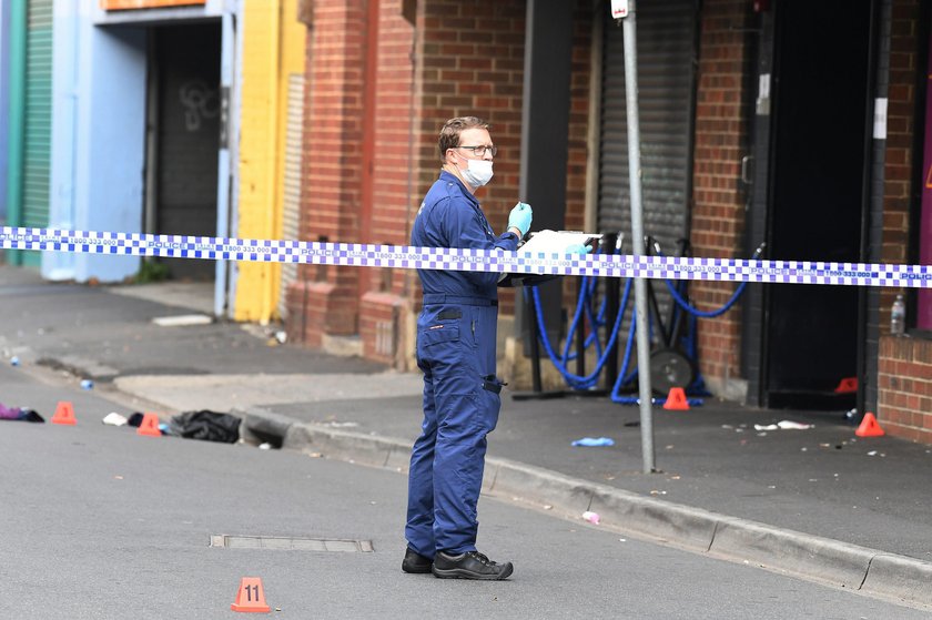 A Victoria Police personnel works at the scene of a multiple shooting outside Love Machine nightclub