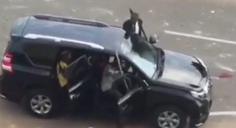 Hoodlums and some men in black suit driving towards protesters in Abuja (The Cable)