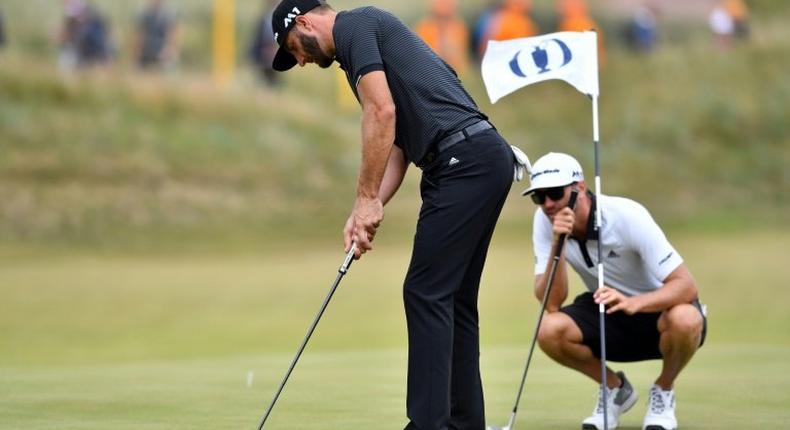 US golfer Dustin Johnson putts on the 14th green during a practice round at Royal Birkdale golf course near Southport, north-west England, on July 19, 2017, ahead of the 146th British Open