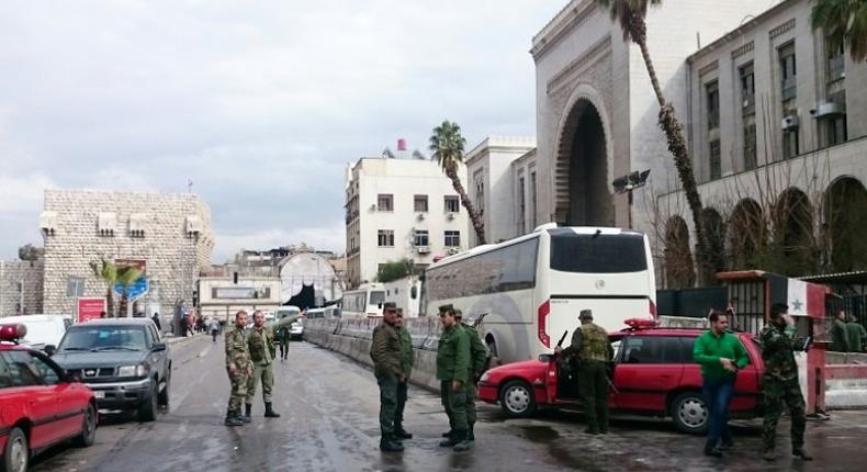 Syrian security forces cordon off the area following a suicide at a courthouse in Damascus on March 15, 2017