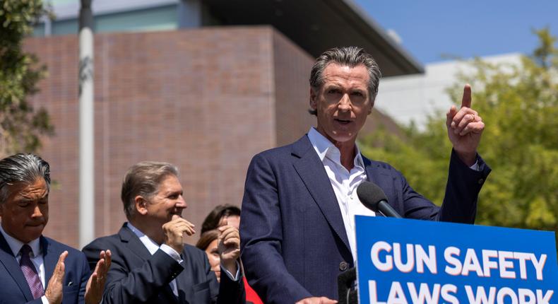 California Attorney General Rob Bonta (L) and Senate Majority Leader Emeritus Bob Hertzberg applaud as California governor Gavin Newsom address a news conference where he signed SB 1327 into law on July 22, 2022 in Los Angeles, California.