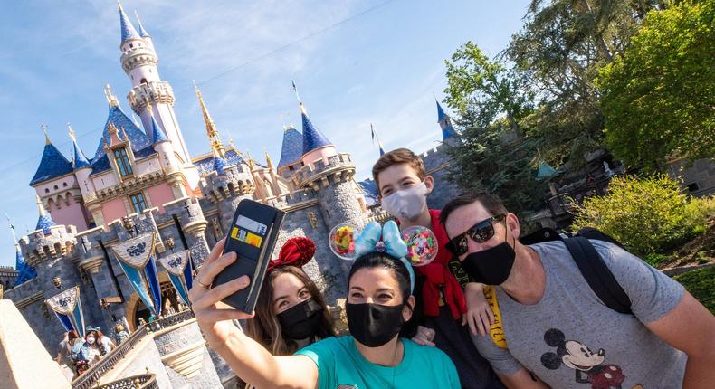 Visitors pose for a selfie at the Disneyland Resort on April 30, 2021 in Anaheim, California