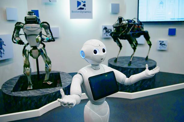 Humanoidalny robot Pepper, za nim stoją roboty Atlas i Spot