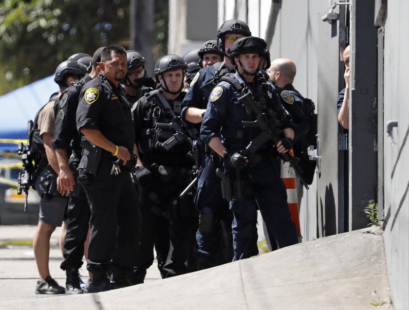 United Parcel Service vans are seen parked outside a UPS facility after a shooting incident was repo