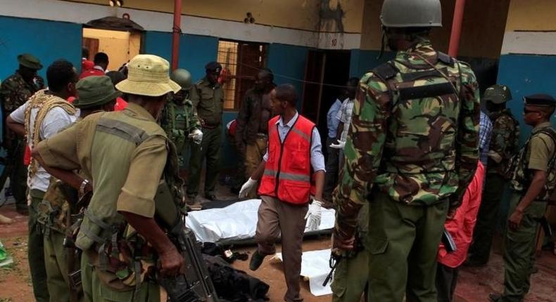 Police officers stand by dead bodies after an attack by Islamist militants from the Somali group al Shabaab in Mandera, Kenya, October 6, 2016. 