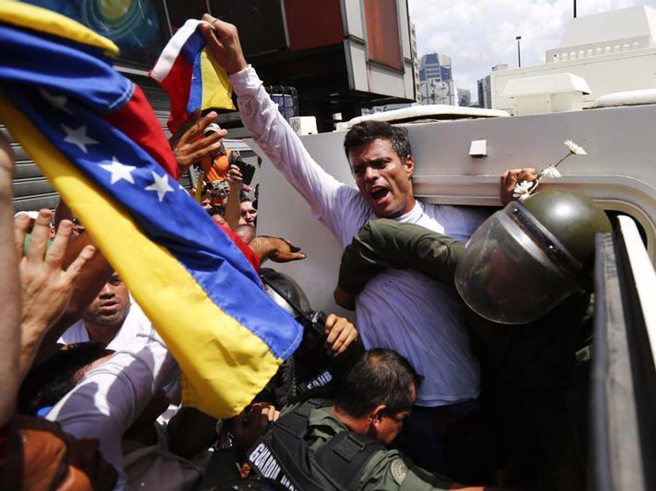 Venezuelan opposition leader Leopoldo Lopez gets into a National Guard armored vehicle in Caracas