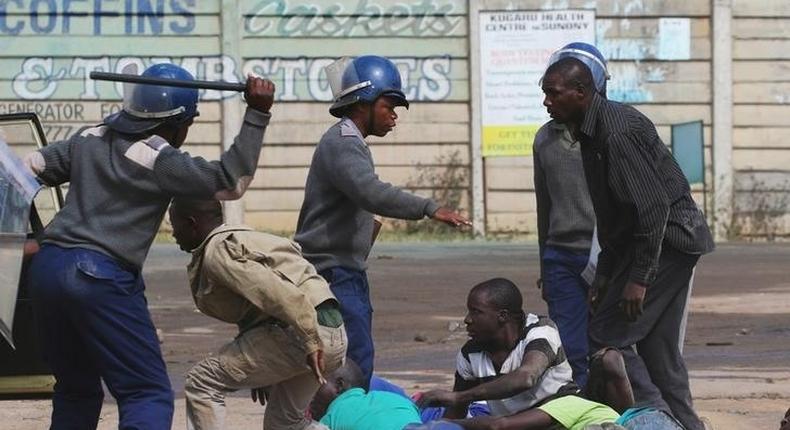 Riot police detain residents of Epworth suburb after a protest by taxi drivers turned violent in Harare, Zimbabwe, July 4, 2016. 