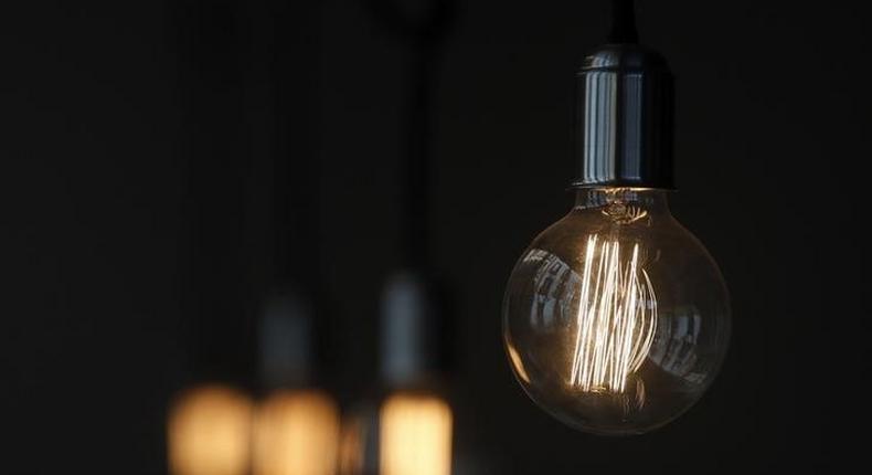 A bulb hangs inside a restaurant in Madrid December 23, 2013. REUTERS/Andrea Comas