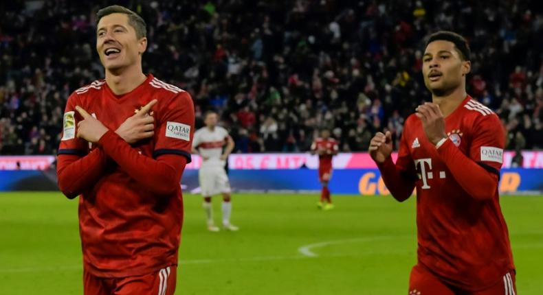 Robert Lewandowski (L) celebrates scoring his 12th Bundesliga goal of the season