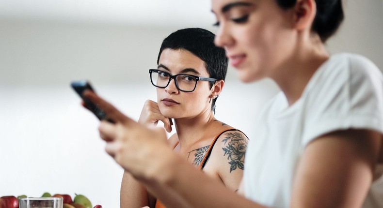 Obsessing about where your partner is or who they're texting could be a sign of self-sabotage.Diego Cervo / EyeEm/Getty Images