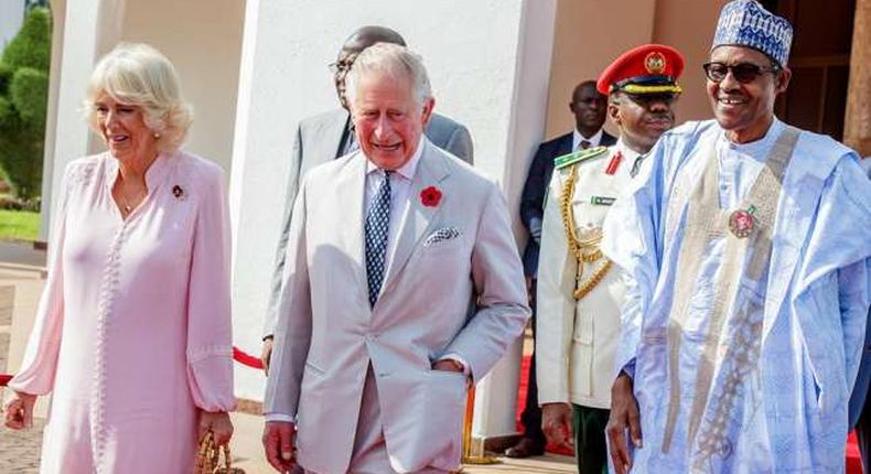 Prince Charles (M) and his wife Camilla, the Duchess of Cornwall (L) and President Buhari (R)