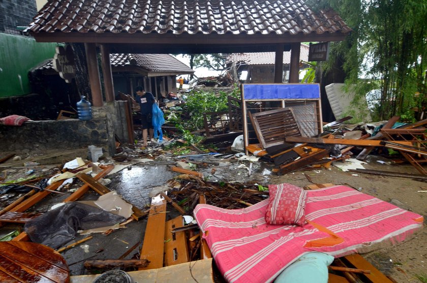 A man stands among ruins after a tsunami hit at Carita beach in Pandeglang, Banten province