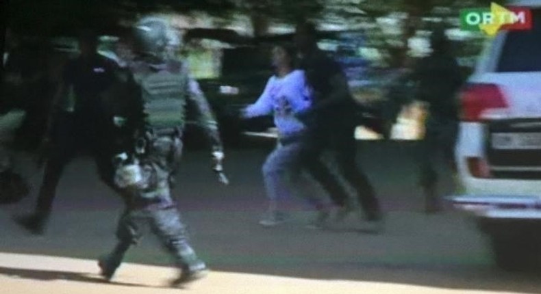 Still image from video show a hostage rushed out from the Radisson hotel in Bamako, Mali, November 20, 2015.  REUTERS/REUTERS TV