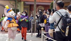 A staff member dressed as LinaBell waves to visitors at Shanghai Disney Resort.Xinhua/Getty Images