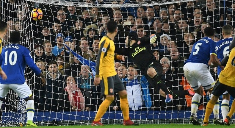 Everton defender Ashley Williams (2R) scores his team's second goal after a disputed corner award