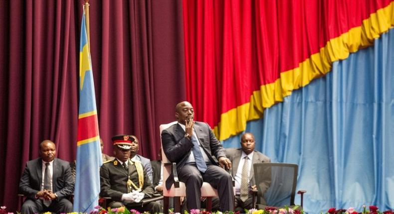 Congolese President Joseph Kabila (C), seen in November 2016, will stay on until the end of 2017, under the terms of a new political deal between the government and opposition parties