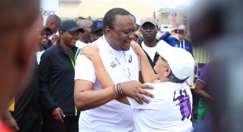 First Lady Margaret Kenyatta receives President Uhuru Kenyatta after competing in the Beyond Zero Half Marathon