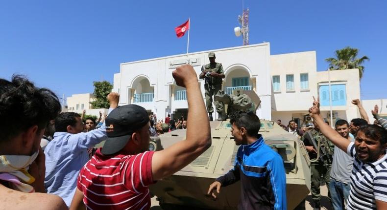 Tunisian protesters gather outside the Tataouine governor's office on May 22, 2017, in solidarity with a sit-in outside an oil and gas installation in the same province to demand jobs