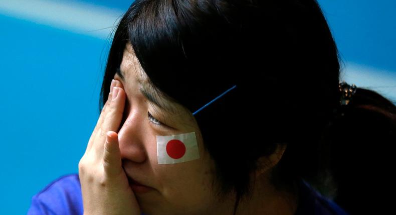 A Japanese soccer fan after Japan loses its 2014 World Cup soccer match against Colombia.
