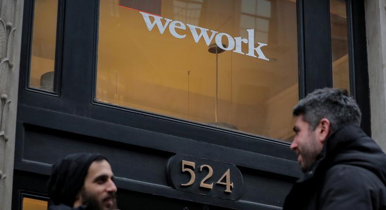 FILE PHOTO: People stand outside a WeWork co-working space in New York City, New York U.S., January 8, 2019. REUTERS/Brendan McDermid/File Photo
