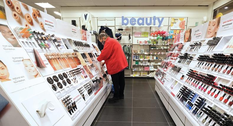 A worker cleans the makeup section inside Hema, a Dutch variety store-chain, in Katwijk, Netherlands on December 16, 2020.
